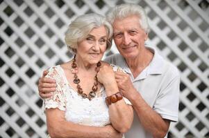 Portrait of elderly couple posing in nature in summer photo