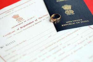 Indian Certificate of registration of marriage blank document and wedding ring with passport on table photo