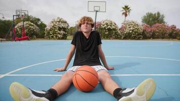 Basketball Player Sitting On The Ground After Basketball Game video