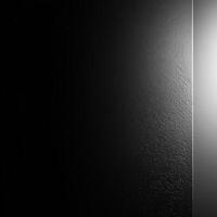 Black Textured Surface with a Light Source on the Right photo