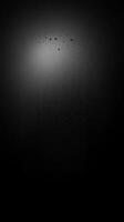 A Vertical Column of Tiny White Spots on a Black Background photo