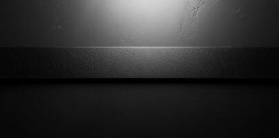 Black Textured Surface with a Horizontal Band and Overhead Lighting photo