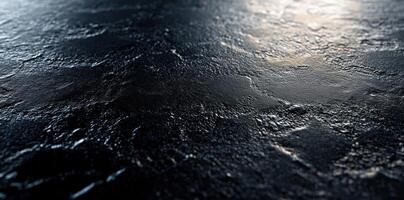 Dark, Textured Surface with Light Reflection photo