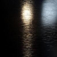 Light Reflecting on a Dark, Textured Surface photo
