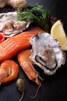 Fresh seafood with lemon, capers and thyme photo