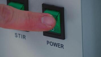 the man finger press the button control on modul operating machine to start machine. photo