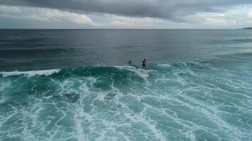 May 10, 2024. Fuvahmulah, Maldives. Aerial view with local surfers on ocean wave. Waves and surfer riding on waves video