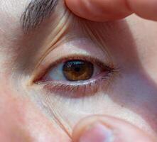 close-up of a human eye, eyelids and eyelashes on a girl's face photo