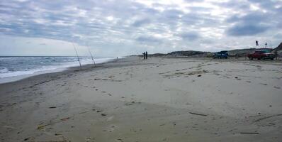 Fishermen on the sandy shore of the Atlantic Ocean in New Jersey, USA photo