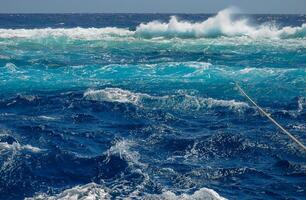 Mooring with a thick rope to the Big Brother island of a diving yacht during a storm photo