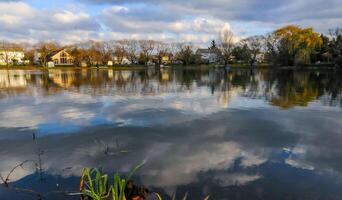 Natural Landscape, Reflection of clouds and lodges in the water of a quiet lake in New Jersey photo