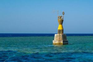 Navigational sign on the dangerous underwater Red Sea photo