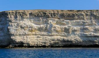 High Coastal cliffs from layered Pontic limestone in the western Crimea, Tarkhankut photo