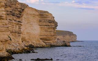 Cormorants rest on a steep bank of Pontic limestone in eastern Crimea photo