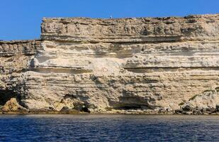 High Coastal cliffs from layered Pontic limestone in the western Crimea, Tarkhankut photo