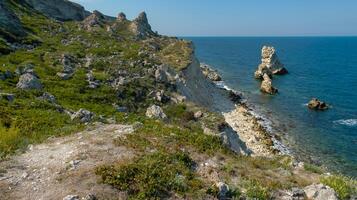 View of the steep banks and rocks in the water in the Dzhangul tract, western Crimea photo