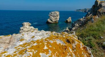 View of the steep banks and rocks in the water in the Dzhangul tract, western Crimea photo