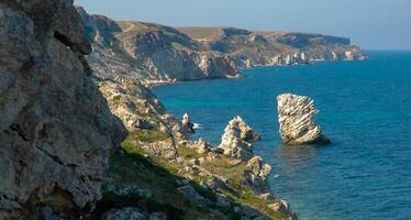 View of the steep banks and rocks in the water in the Dzhangul tract, western Crimea photo