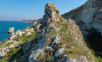 View of the steep banks and rocks in the water in the Dzhangul tract, western Crimea photo