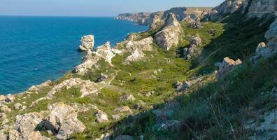 View of the steep banks and rocks in the water in the Dzhangul tract, western Crimea photo