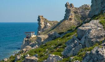 View of the steep banks and rocks in the water in the Dzhangul tract, western Crimea photo