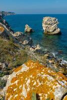 View of the steep banks and rocks in the water in the Dzhangul tract, western Crimea photo