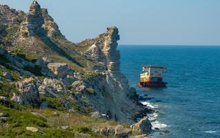 View of the steep banks and rocks in the water in the Dzhangul tract, western Crimea photo