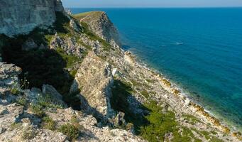 View of the steep banks and rocks in the water in the Dzhangul tract, western Crimea photo