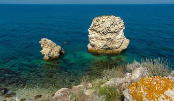 Rocks and islands in the water of the Black Sea near the landslide coast of Dzhangul in the western Crimea, Tarkhankut photo