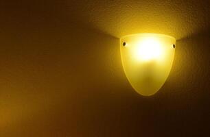 Lamp with yellow light in the corner of the room, room design photo
