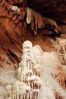Calcite inlets, stalactites and stalagmites in large underground halls in Carlsbad Caverns NP, New Mexico photo
