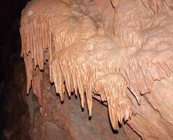 Calcite inlets, stalactites and stalagmites in large underground halls in Carlsbad Caverns NP, New Mexico photo