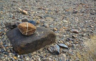 Sun-scorched, lifeless, stony, dry desert in the foothills of California photo