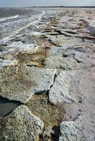 The shore of a hyperhaline lake covered with self-precipitating salt Sodium chloride, California photo