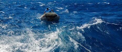 Egyptian on an inflatable rubber boat providing diving in the Red Sea photo