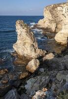 High limestone coastal cliffs against the backdrop of the Black Sea on Tarkhankut, Atlesh, western Crimea photo