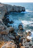 High limestone coastal cliffs against the backdrop of the Black Sea on Tarkhankut, Atlesh, western Crimea photo