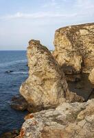 High limestone coastal cliffs against the backdrop of the Black Sea on Tarkhankut, Atlesh, western Crimea photo