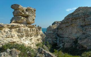 View of the steep banks and rocks in the water in the Dzhangul tract, western Crimea photo