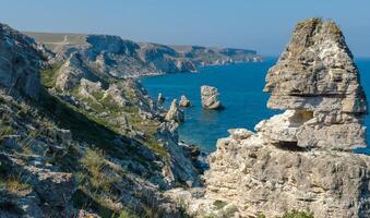 View of the steep banks and rocks in the water in the Dzhangul tract, western Crimea photo