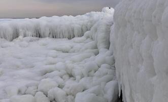 Coastal cliffs and coastal protection structures frozen with ice in the cold winter of 2010, the Black Sea photo