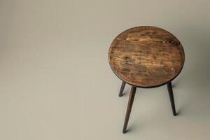 Rustic round wooden stool on a neutral backdrop, showcasing craftsmanship and simplicity in design photo
