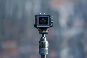 A compact camera on a tripod capturing stunning outdoor landscapes at sunset photo