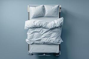 Cozy, rumpled bed with fresh white linens in a softly illuminated room during a tranquil morning photo