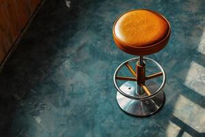 A solitary bar stool basking in afternoon sunlight on a patterned floor photo