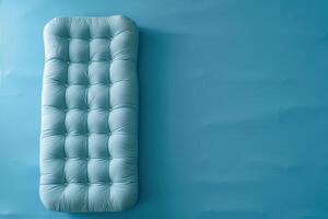 Cozy vintage mattress on a soft blue background creating a serene atmosphere in a minimalist space photo