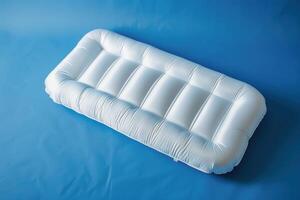 Inflatable white lounge bed resting on a calm blue surface, inviting relaxation in a serene environment photo