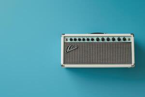 Vintage-style amplifier on a vibrant turquoise background creating a retro music vibe photo