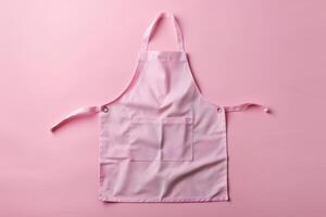 A charming pink apron laid out on a soft pastel background, perfect for culinary adventures or crafting moments photo