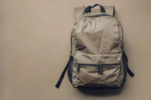 A minimalist backpack resting against a muted background in a cozy indoor setting during the afternoon photo